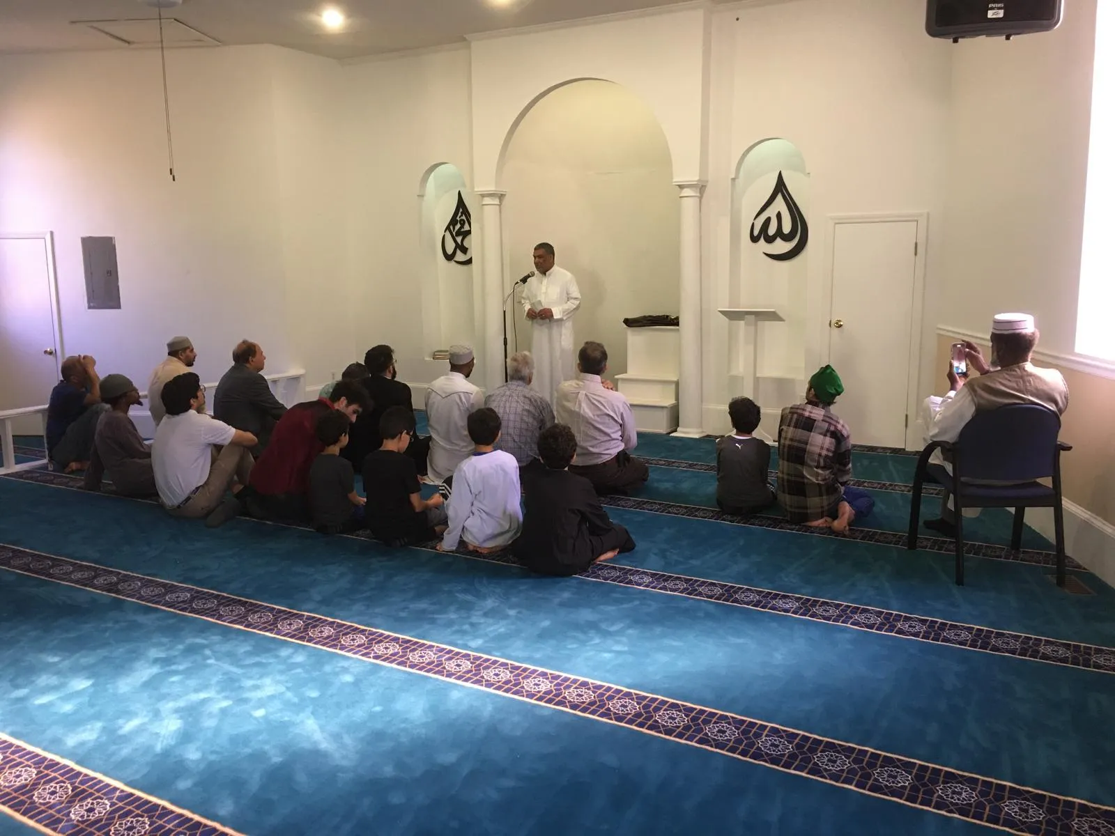 A congregation listening inside Aiken Masjid