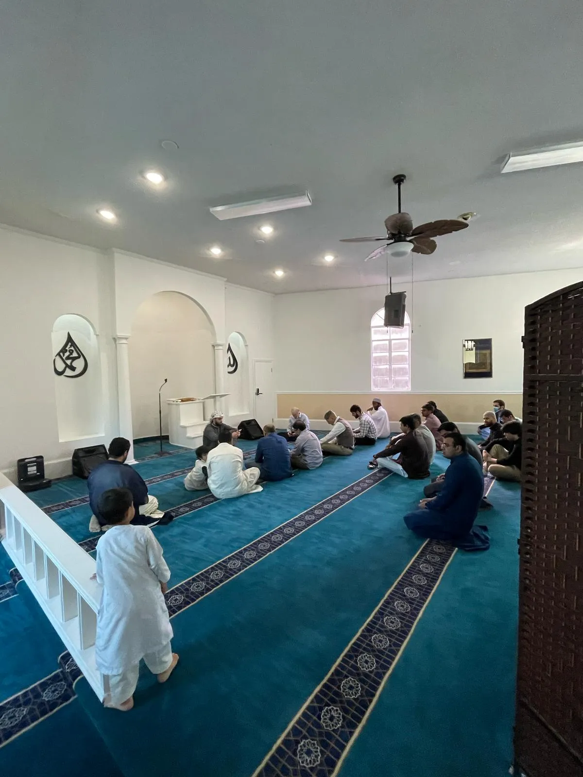 Congregation seated in the prayer hall